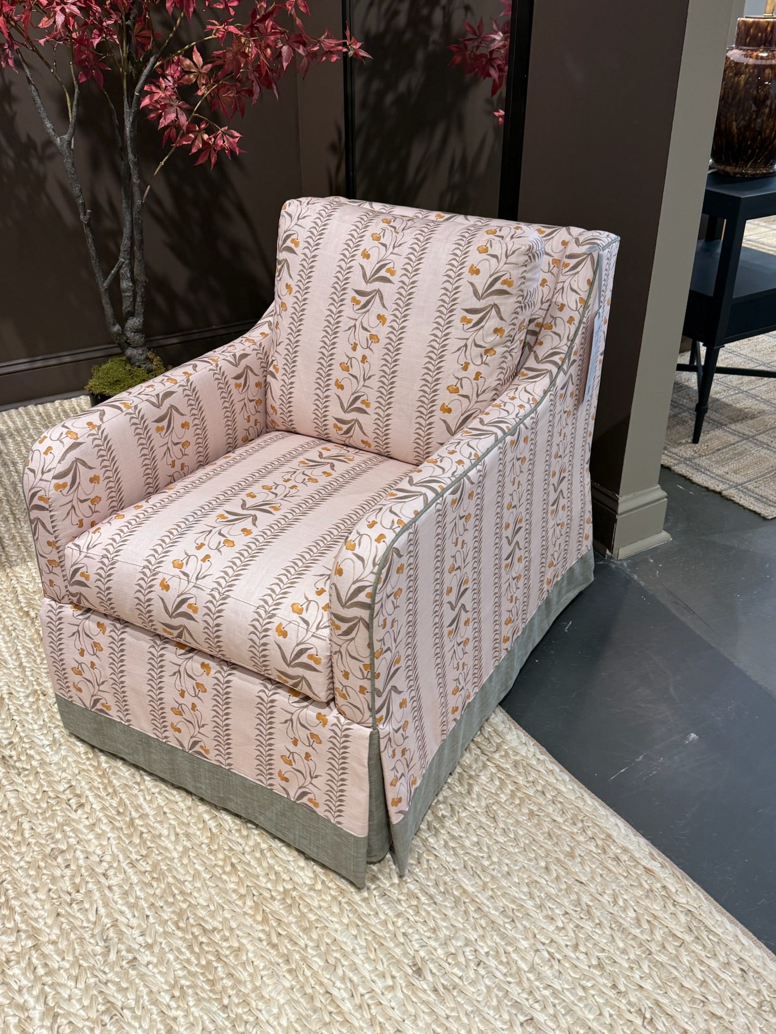 EH x Renee Bouchon Tula Fabric Yardage in Daffodil, a pink linen armchair with floral and striped patterns.