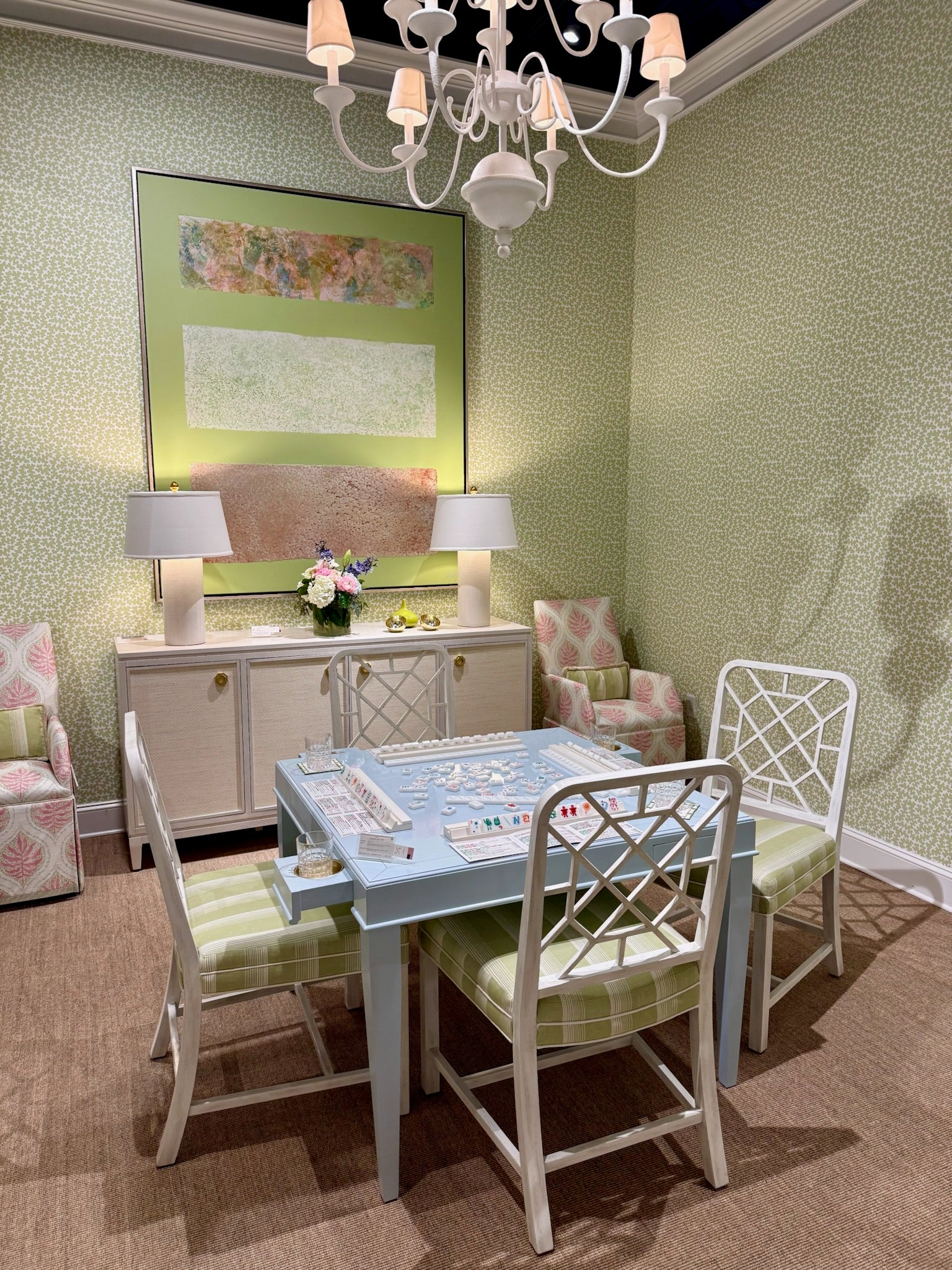 Dover Apple clay coated wallpaper with a subtle green pattern in a room with a game table and chairs.