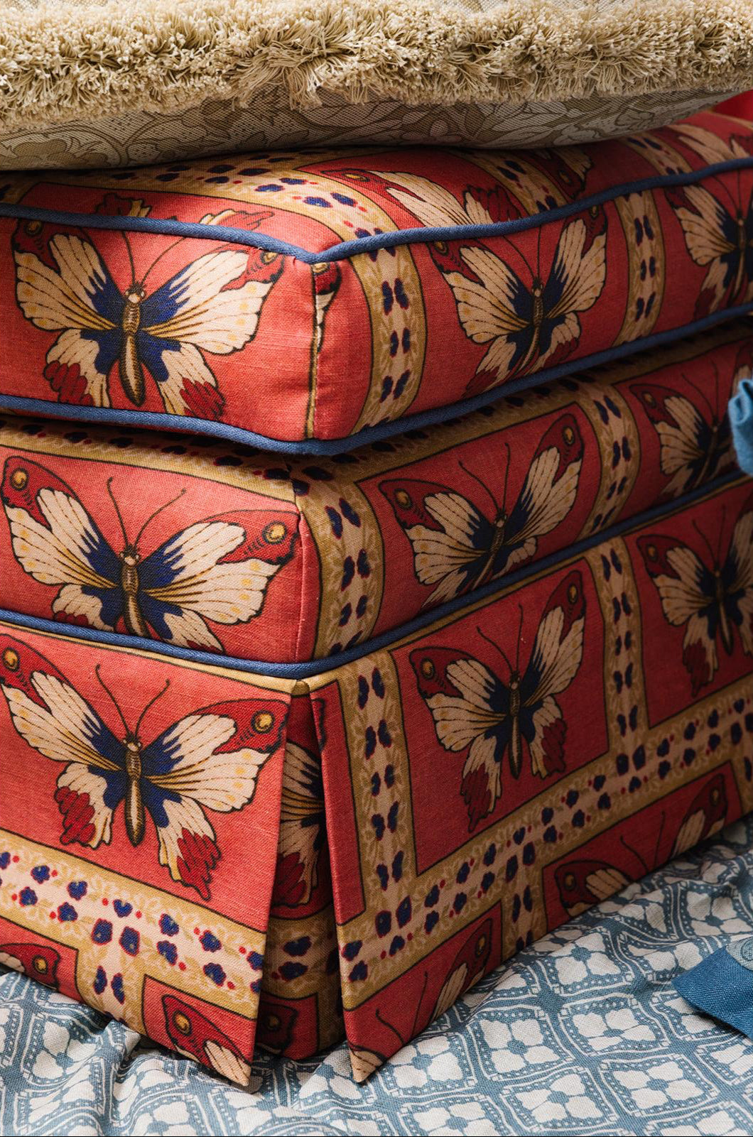 Ottoman in Monarch Rouge fabric with contrast welt
