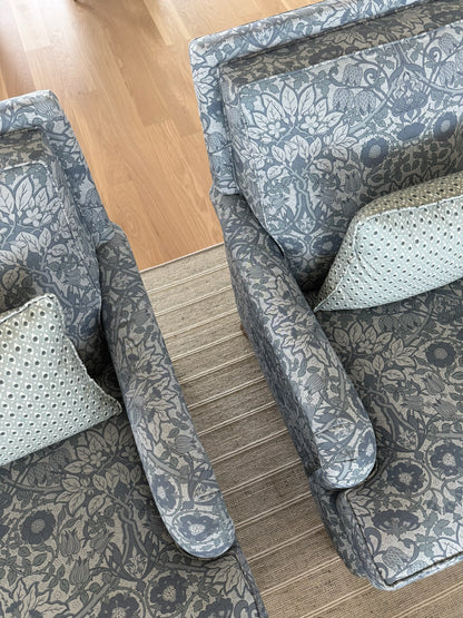 Two Della Dot Pillows in Marine, featuring a blue-grey floral pattern on cotton-blend fabric, with light dotted accent pillows.