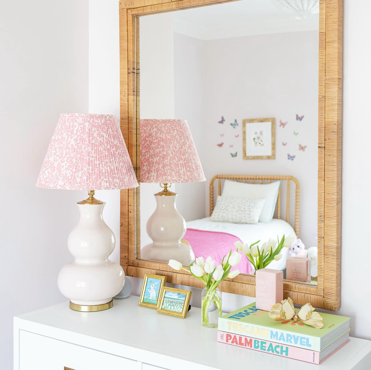 Dover Fabric - Blossom, a pink floral linen-cotton blend fabric on pleated lampshades, reflected in a rattan mirror.