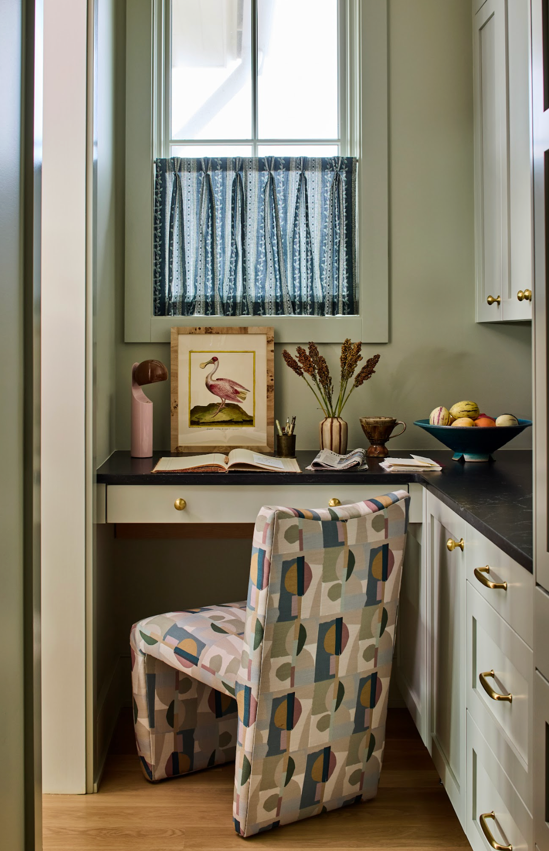 Marine Trellis Fabric window treatment in a home office with a colorful patterned chair.