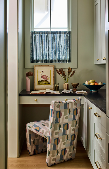 Marine Trellis Fabric window treatment in a home office with a colorful patterned chair.