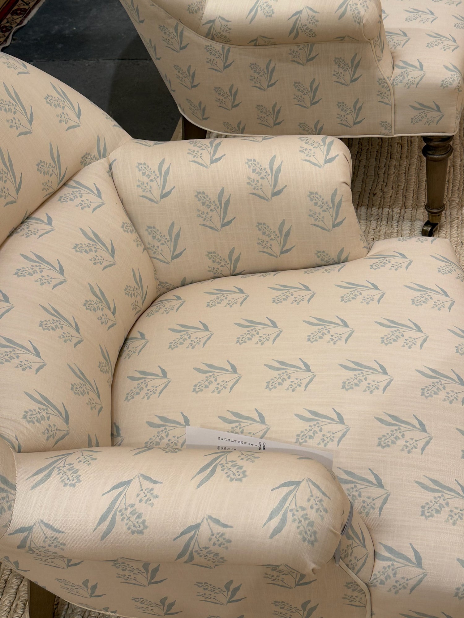 EH x Renee Bouchon Marbella Sea linen fabric with light blue botanical pattern on an armchair.