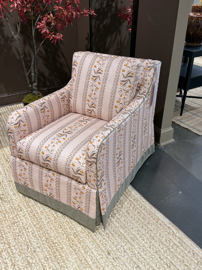EH x Renee Bouchon Tula Fabric Yardage in Daffodil, a pink linen armchair with floral and striped patterns.