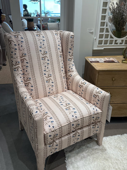 Wingback chair upholstered in EH x Renee Bouchon Tula fabric in Lapis, featuring pink linen with blue floral stripes.
