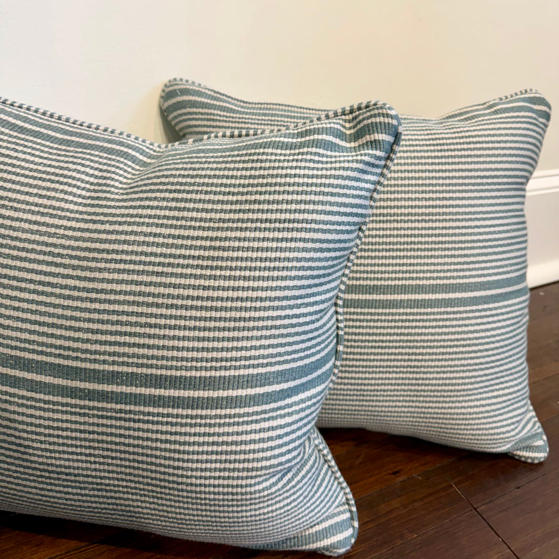 Pair of 18x18 EH x Sunbrella Thorton Surf pillows with blue and white horizontal stripes.