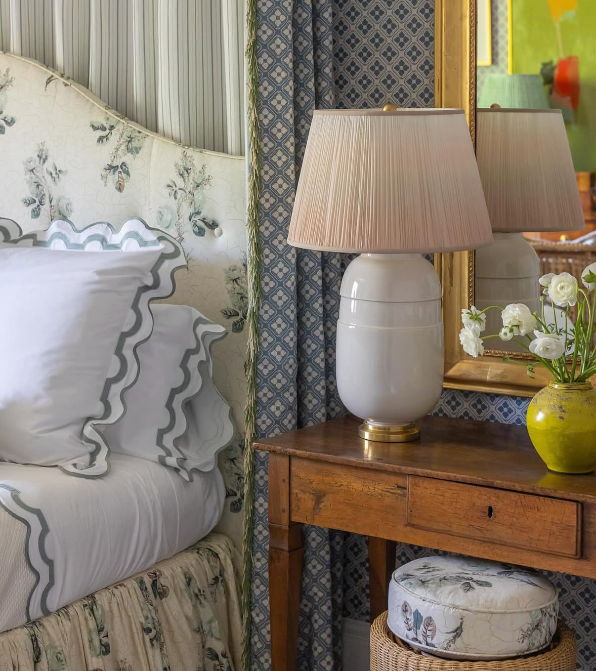 French Blue Echo Fabric with floral pattern on a headboard, paired with patterned curtains and a bedside table.