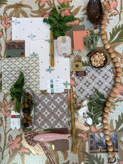 Sparrow Fabric in Sea Salt linen, a flat lay with design swatches, olives, herbs, and wooden beads.