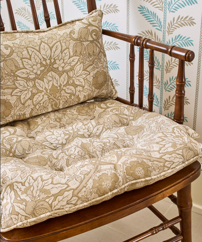 Putty Flora Fabric Belgian Oyster Linen cushions on a wooden chair, featuring an intricate floral pattern.