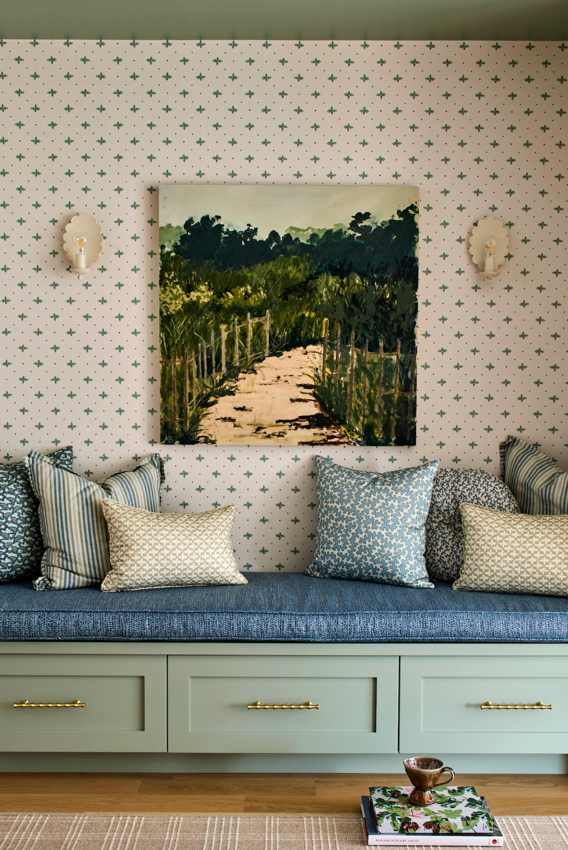 Dover Pillow in House Blue, a cotton-blend pillow with a subtle geometric pattern, shown on a blue window seat.