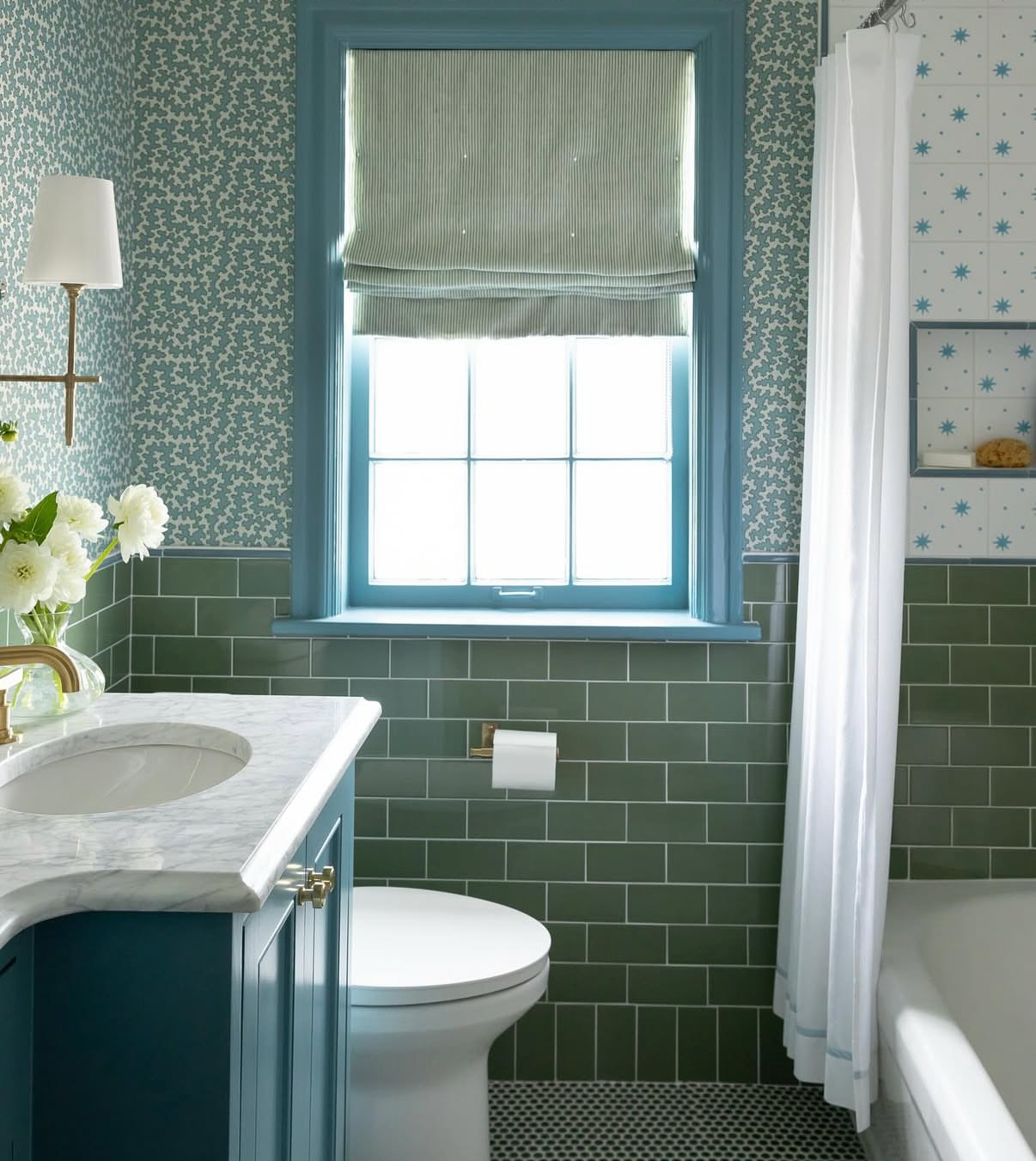 Dover Wallpaper in House Blue with a small floral pattern, paired with green subway tiles in a bathroom.