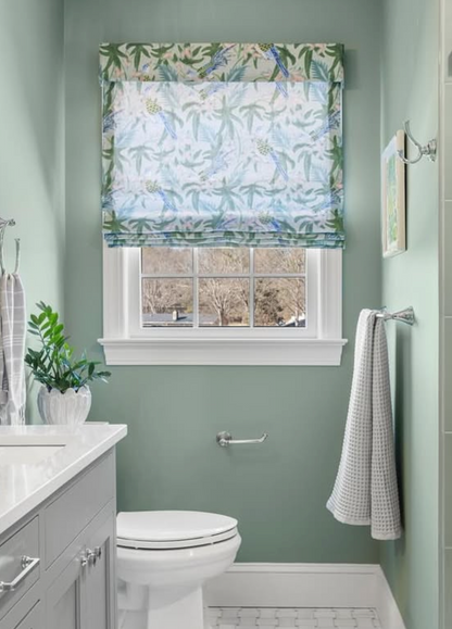 Sparrow Fabric - Caribbean Belgian Linen roman shade with blue parrots and palm leaves in a bathroom.