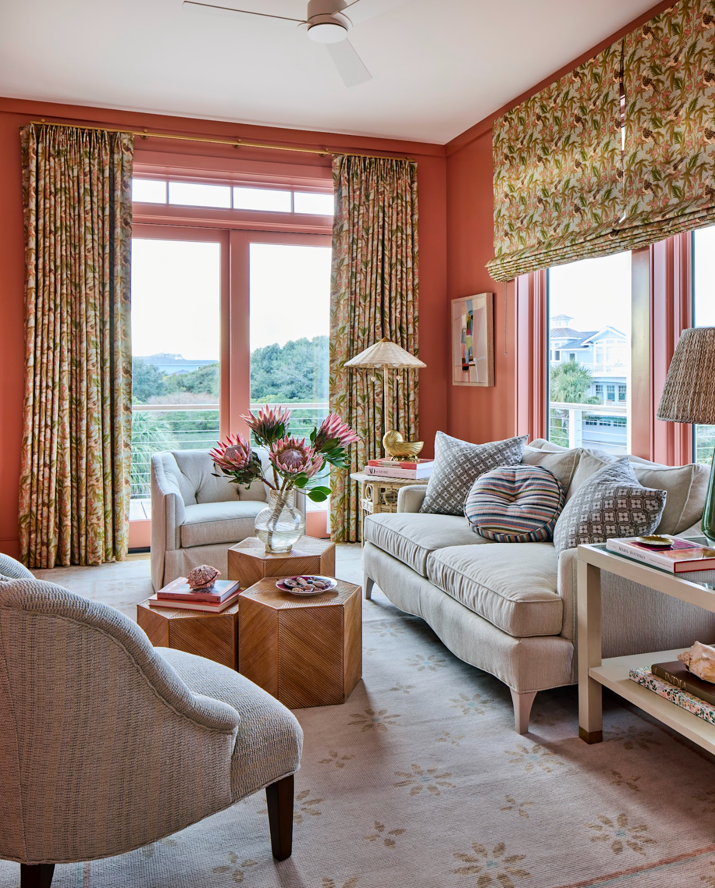 Living room with coral walls, linen Sparrow Fabric curtains, and a beige sofa.