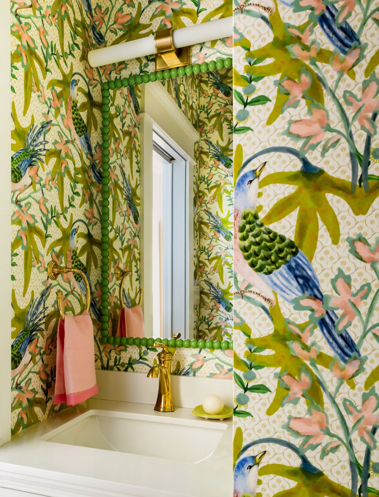 Sparrow Wallpaper - Citrus with green foliage, pink flowers, and blue birds in a bathroom setting.