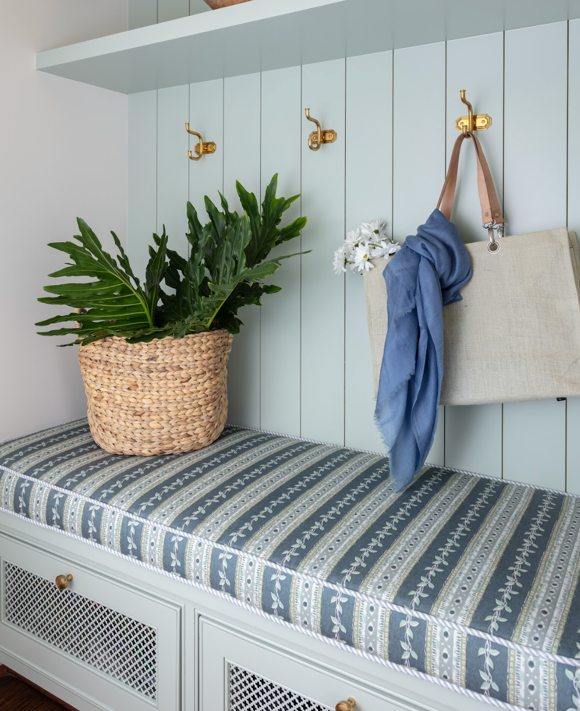 Marine Trellis Fabric bench cushion with blue and white striped floral design, on a light green mudroom bench.